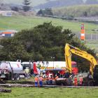 New Zealand Refinery staff at the site of a fuel pipeline leak on farm land between State Highway...