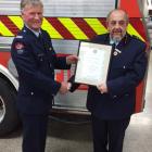 Oamaru Volunteer Fire Brigade’s long-serving senior firefighter Mike Isbister (left) and chief...