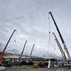 A commercial building’s 80-tonne steel roof was lifted in place by six cranes at Queenstown’s...