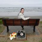 Sarah Baker sits on the memorial seat for her brother, Riley, near Shag Point yesterday. Photo:...
