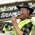 Port Chalmers Seafood Festival volunteer Dave Kearns enjoys a whitebait fritter as other...