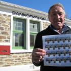 Bannockburn volunteer Edgar Parcell shows off the commemorative Bannockburn stamp at a special...