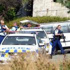 Armed police gather at Seacliff after the incident in March last year. Photo: Stephen Jaquiery
