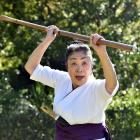 Japanese martial arts teacher Shimizu Nobuko Sensei (75) prepares to strike with her naginata at...