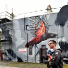 Artist Deow Owen, of Southland, after finishing his striking kaka mural on North Rd yesterday....