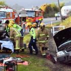 Emergency services tend to the driver of a four-wheel-drive, who was trapped in his vehicle after...