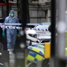 A forensics officer walks near the Natural History Museum, after a car mounted the pavement, in...