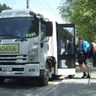 Wakatipu High School pupils board a school bus on Gorge Rd yesterday. Photo: Guy Williams