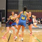 Epsom Girls' goal attack Bianca Nagaya (centre) is challenged by St Hilda's goal keep Mara...