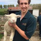 Veterinary science student Paul Blondell gets up close with a lamb. PHOTO: SUPPLIED