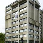 A banner, weighted with a mortarboard, protesting about staff cuts at the University of Otago...