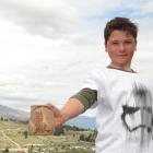Queenstown youngster Peter Bodie-Healy shows the flagon he designed with Weta Workshop staff...