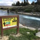A new sign near the Hawea Whitewater Park warns surfers of the dangers of becoming tangled around...