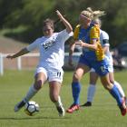 WaiBop's Kat Robinson (left) tries to control the ball in a match at Tahuna Park on Saturday,...
