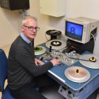 NHNZ technical and IT systems manager Wayne Poll plays with an old videotape machine at the...