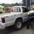 The ute which ploughed into the building of neighbouring businesses Carpet Flooring Xtra and...