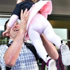 Ben Smith spends time with his daughter, Annabelle, before boarding the team bus. Photos by Peter...