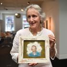 Otago Embroiderers Guild member Jenny Madill holds a work by Kingston artist Amy Baker, depicting...