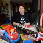 Foster Hope Otago co-ordinator Juanita Willems, in her Mosgiel home, wraps some Christmas...