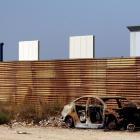 Prototypes for US President Donald Trump's border wall with Mexico are seen behind the current...