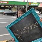 Caversham Four Square owner Sandra Shum is searching for a lucky customer yet to claim their $200...