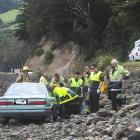 Fire and Emergency services attend to an elderly man who  was trapped in his car after it went...