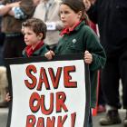 Stuart HoreBen (6) and Ella (10) Gibson, of Ranfurly, protest against Westpac’s closure of the ...