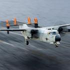 The propeller-powered transport plane, a C-2 Greyhound, carries personnel, mail and other cargo...