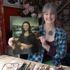 Victoria Heatherbell holds an image of her painting of Prime Minister Jacinda Ardern in the style...