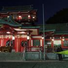 A policeman stands guard in front of the main temple of the Tomioka Hachimangu shrine in Tokyo,...