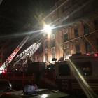 New York Fire Department ladder trucks deploy at a building fire in the Bronx borough of New York...
