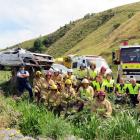 Senior Constable Craig Bennett (left), of Lawrence, and members of Fire and Emergency New Zealand...