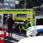 A woman is stretchered to a waiting ambulance after coming off a hired scooter in Shotover St...