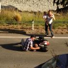 Members of the public help an injured motorcyclist in Fernhill Rd, Queenstown, last night. Photo:...
