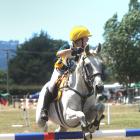 Kyla Garmonsway (13) looks for the next jump to take on her horse, Southwind Summer Rose. They...
