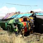 Workers stand next to a wreckage after a train crash near Hennenman in the Free State province....