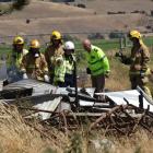 Fire officers and police search the remains of the rural Lake Hawea dwelling which was destroyed...
