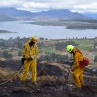 Gore Volunteer Fire Brigade officers Joe Natuikata (left) and Johnathon Moate dig up and...