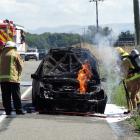 Fire crews were called after this car went up in flames near Oamaru today. Photo Daniel Birchfield