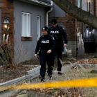 Police officers guard the grounds of a house they had searched in Toronto. Photo: Reuters