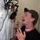 Christian Tucker performs one of his poems in his makeshift recording studio. Photo: Stephen...