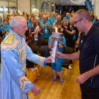Dunedin’s sports liaison  co-ordinator Geoff Simons (left) hands over the Masters Games ...