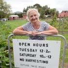 Green Island community garden co-ordinator Marion Thomas with a new sign to discourage theft from...
