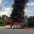 A fire engulfs a Trafalgar bus at the Jones Family Fruit Stall in Cromwell in January. PHOTO: BOB...