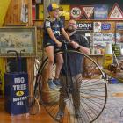 Proctor Auctions manager Ronnie Proctor holds son Jack (8) steady on a vintage penny-farthing...