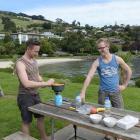 German honeymooners Hendrik (left) and Bastion Schons prepare lunch next to Macandrew Bay beach,...