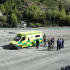 A rescue helicopter lands on the beach by Edith Cavell Bridge, Arthurs Point, about noon today,...