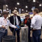Te Pari Products' United States representative Brian Siekman (left), brand ambassador Baxter Black (third from left) and sales and marketing director Jeremy Blampied (right) discuss drenching options with a customer at the National Cattlemen's Beef Associ
