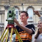 Fourth-year surveying students Jackson Clark (21) and Jess Smyth (21) with a ``total station'',...