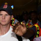 Former Australian cricket captain Steve Smith is escorted by police officers while leaving South...